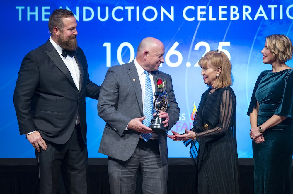 Brad Beauchamp, president and CEO of Carpenter Co., second from left, receives an award on behalf of Stanley F. Pauley, who was inducted into the American Home Furnishings Hall of Fame Oct. 26.