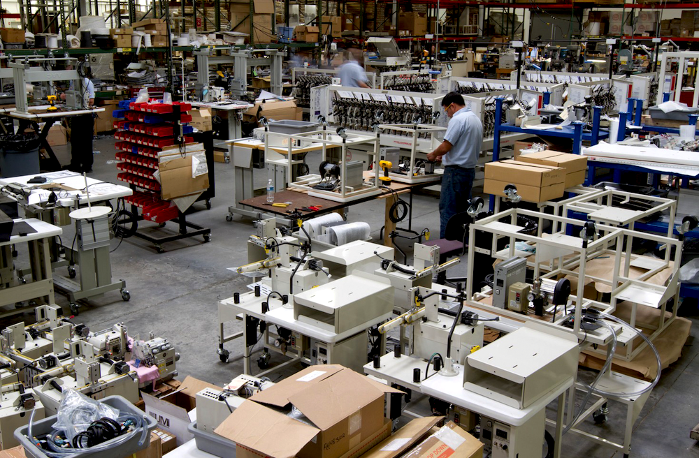 Parts surround an employee on the assembly floor at Atlanta Attachment Co., which is headquartered in Lawrenceville, Georgia.