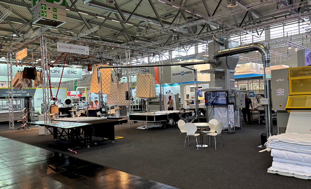 At its booth at Interzum Cologne in May, Gribetz displayed the Waste-Exit waste handling system and a material handling system from Eton Systems. In the photo on the right, the Waste-Exit system is set up in a mattress manufacturer’s quilting area.