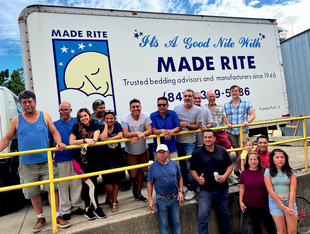 The team at Made Rite Bedding in Franklin Park, Illinois, pose outside the factory during a summer barbecue.