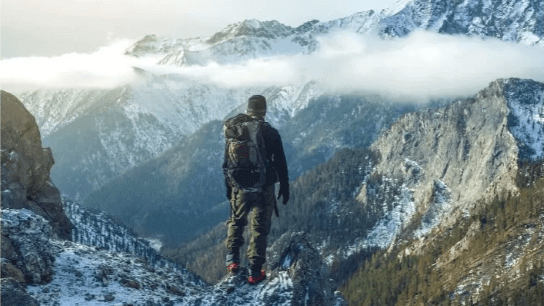 Man standing on a moutaintop.